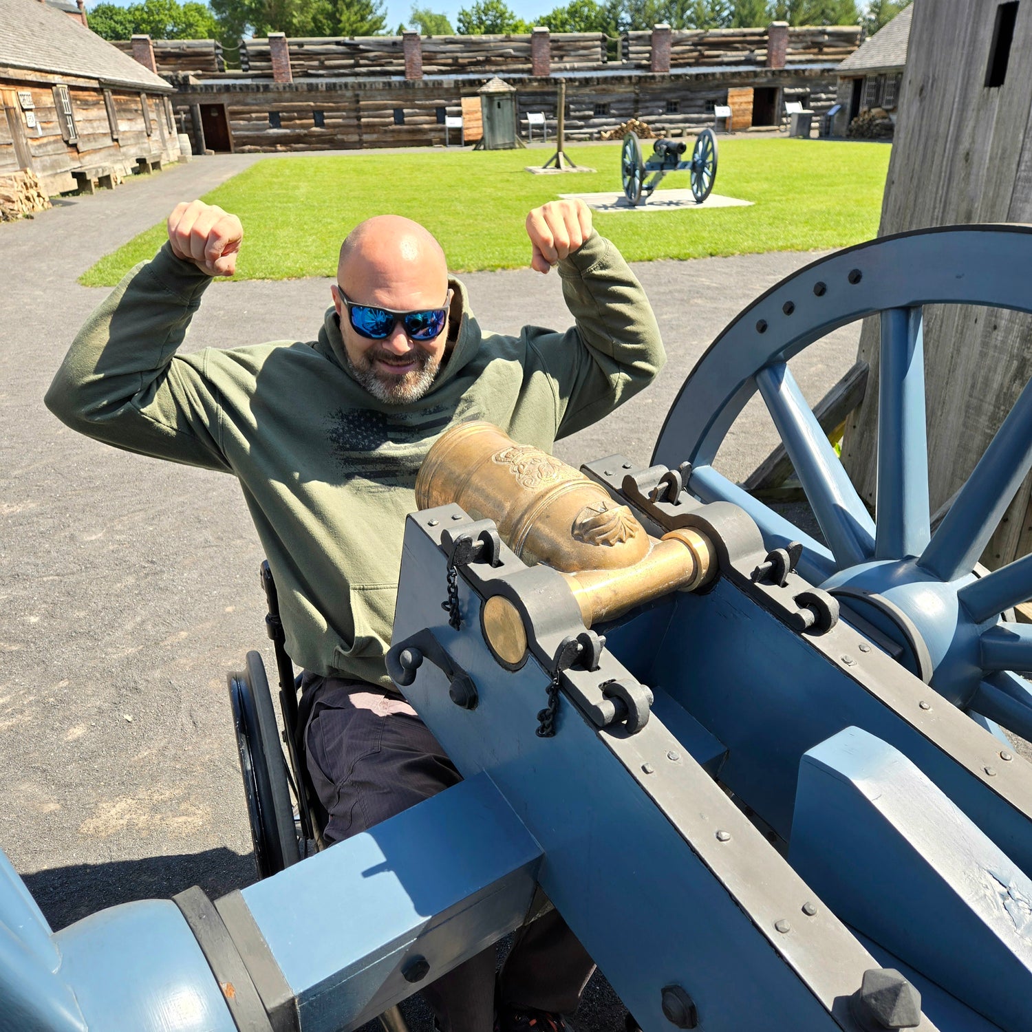 Evan operating a historical cannon with wooden fortifications in the background