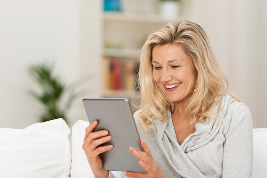 Woman using a tablet computer in a home setting