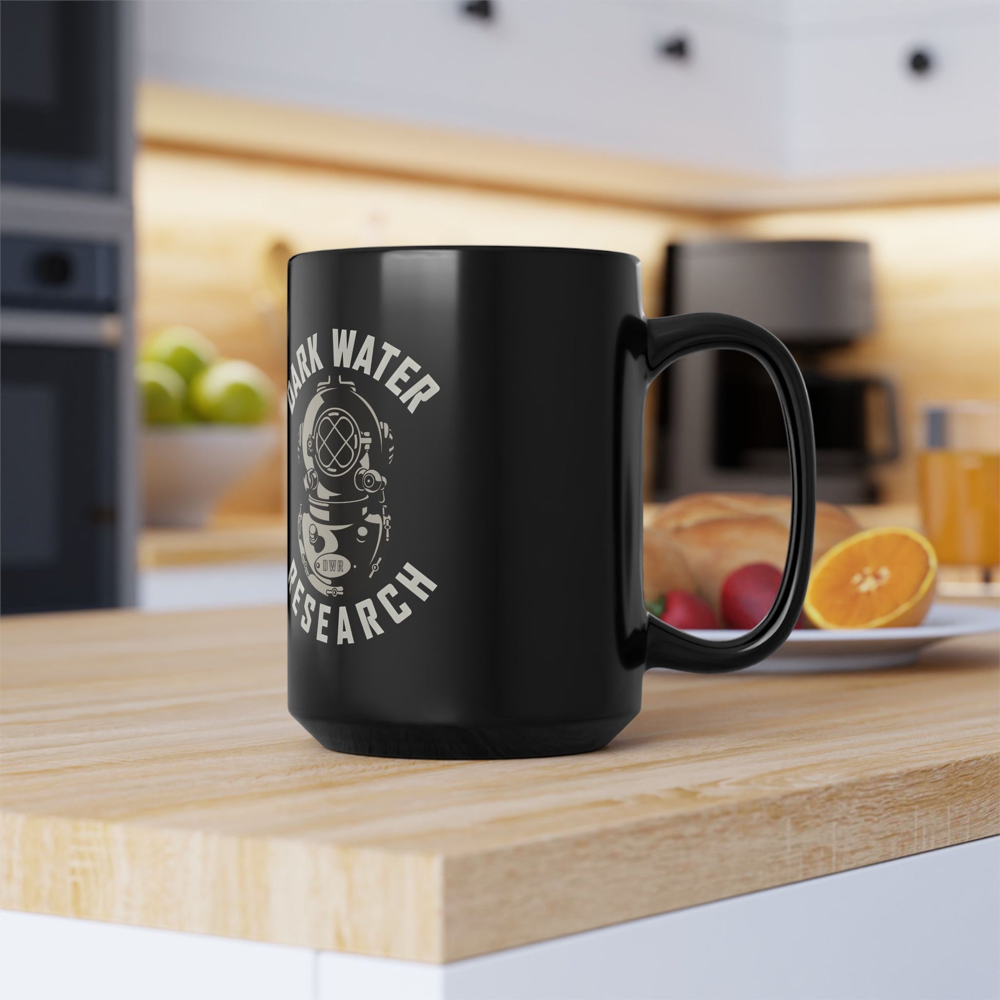 Black mug with 'Dark Water Research' design on a kitchen counter