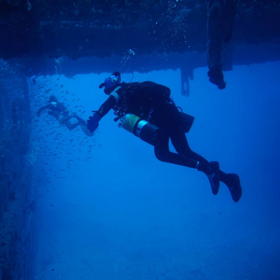 Diver underwater with blue water and light effect