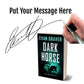 Book titled 'Dark Horse' by Evan Graver with a hand holding a pen and signature on a white background