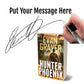 Book titled 'Hunter Phoenix' by Evan Graver with a hand holding a pen and signature overlay.