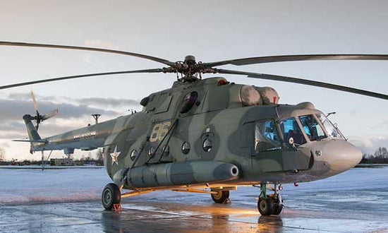 Russian troop carrier helicopter waiting on a wet tarmac for takeoff