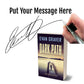 Book titled 'Dark Path' by Evan Graver with a hand holding a pen and signature overlay.
