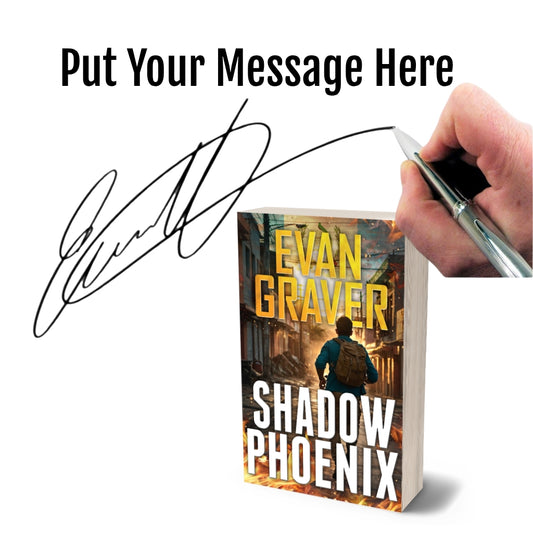 Book titled 'Shadow Phoenix' by Evan Graver with a hand signing it on a white background.