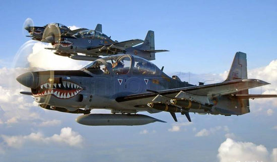 embraer super tucanos flying in formation through cloudy skies