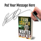 Book titled 'Wanted Phoenix' by Evan Graver with a hand holding a pen and signature overlay.