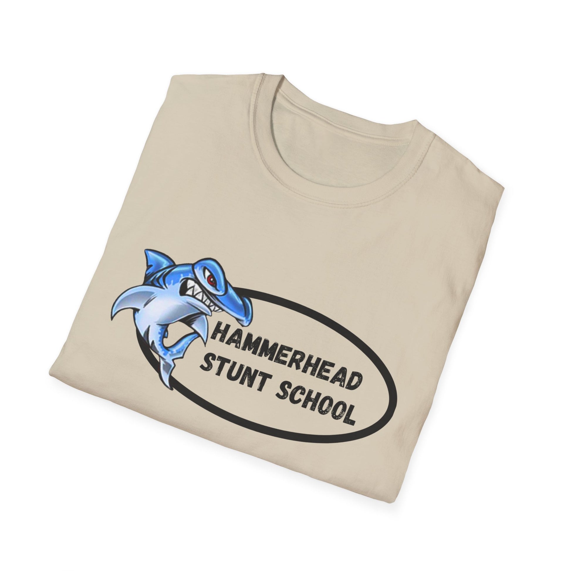 Beige t-shirt with a blue shark graphic and 'Hammerhead Stunt School' text on a white background