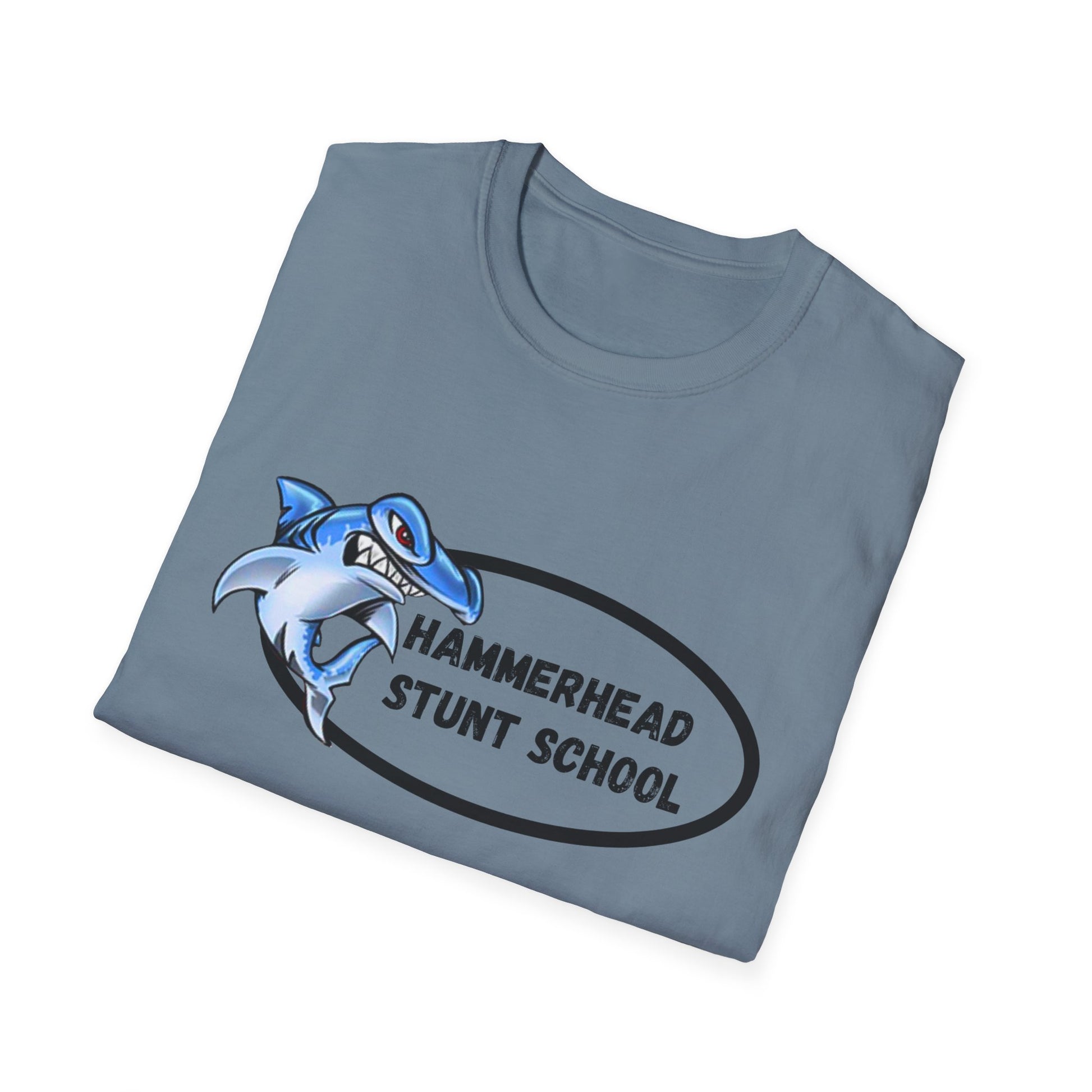 Folded blue t-shirt with a shark graphic and 'Hammerhead Stunt School' text on a white background
